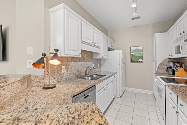 kitchen featuring white appliances, visible vents, a sink, and white cabinetry