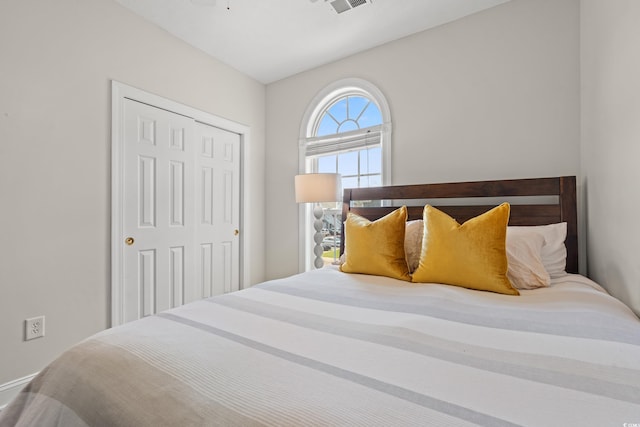 bedroom with a closet and visible vents