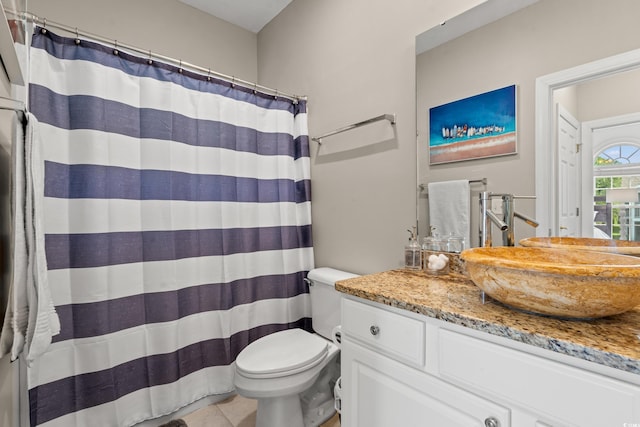 bathroom featuring toilet, curtained shower, tile patterned flooring, and vanity