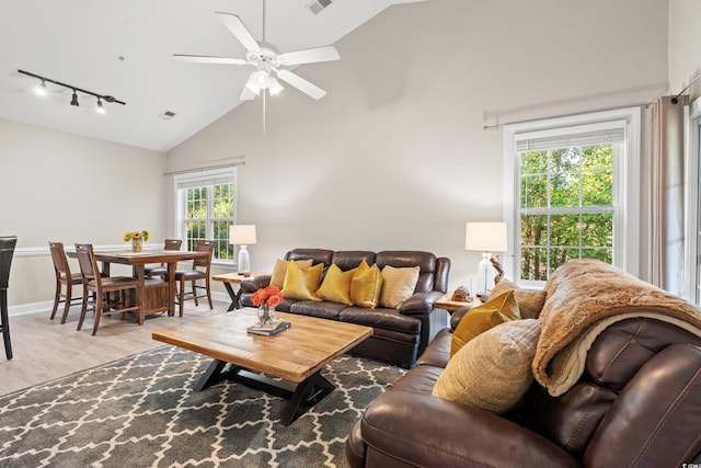 living area featuring high vaulted ceiling, visible vents, ceiling fan, and track lighting