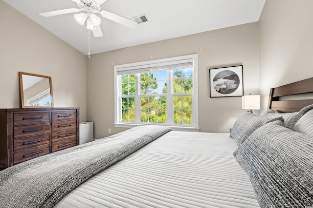 bedroom featuring a ceiling fan, visible vents, and vaulted ceiling