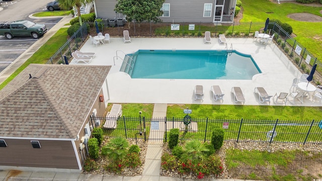 community pool featuring a patio area and fence