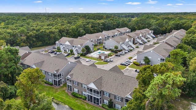 aerial view with a residential view and a view of trees