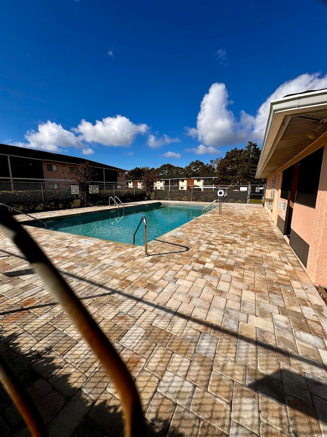 view of swimming pool featuring a patio area