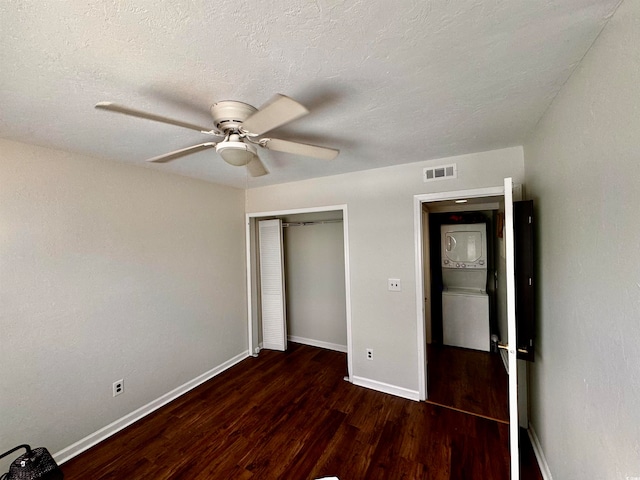 unfurnished bedroom featuring dark hardwood / wood-style flooring, a closet, a textured ceiling, and ceiling fan