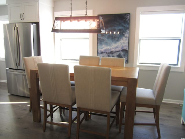 dining space with dark hardwood / wood-style floors