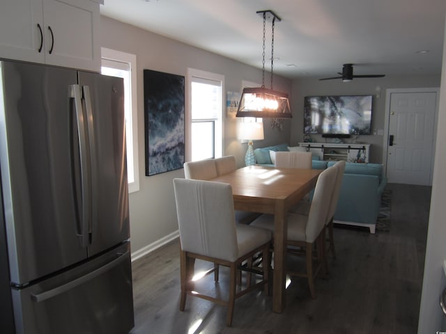 dining space featuring dark hardwood / wood-style flooring and ceiling fan