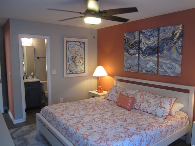 carpeted bedroom with ceiling fan and ensuite bath