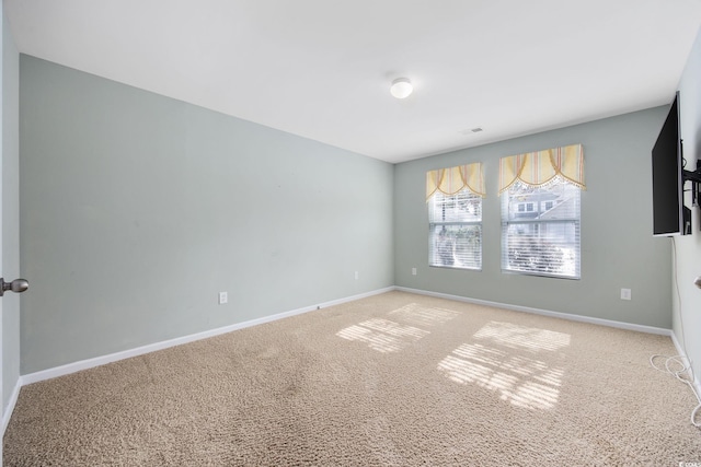 empty room featuring light colored carpet