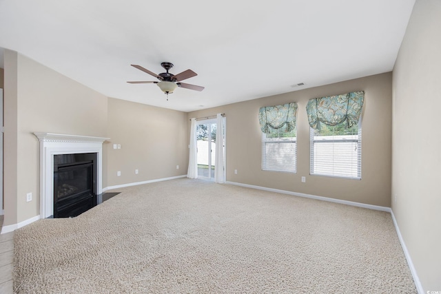 unfurnished living room featuring ceiling fan and light carpet