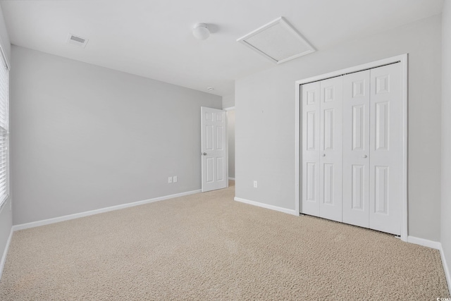 unfurnished bedroom with carpet floors and a closet