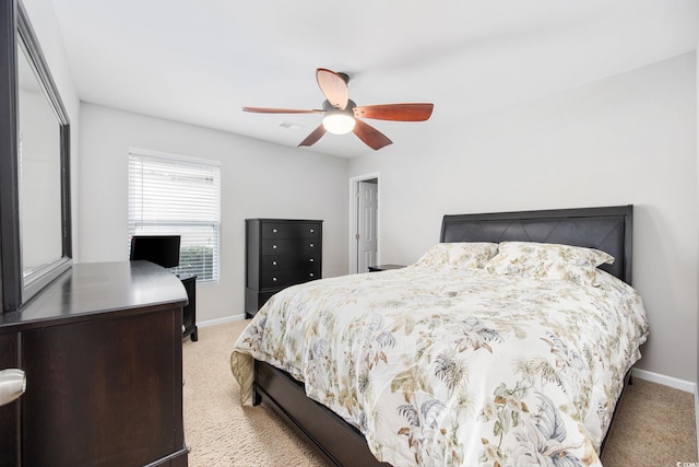 carpeted bedroom featuring ceiling fan and a closet