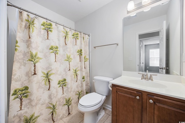 bathroom featuring vanity, tile patterned floors, and toilet