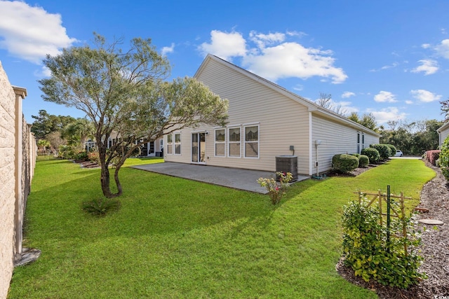 rear view of house with a lawn, central air condition unit, and a patio area