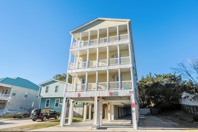 raised beach house featuring a carport