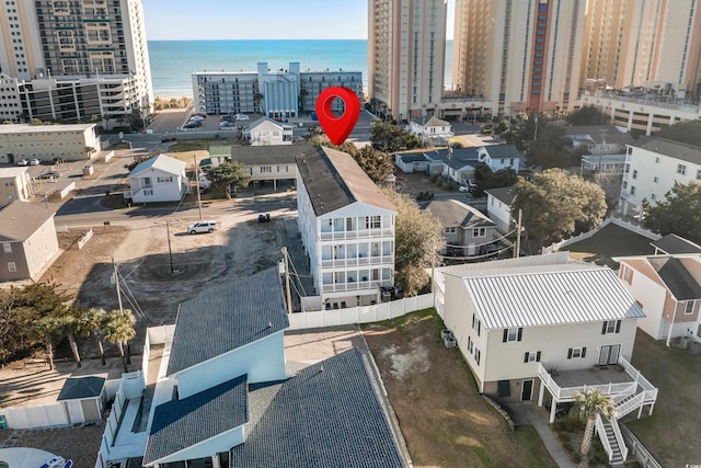 birds eye view of property featuring a water view and a city view