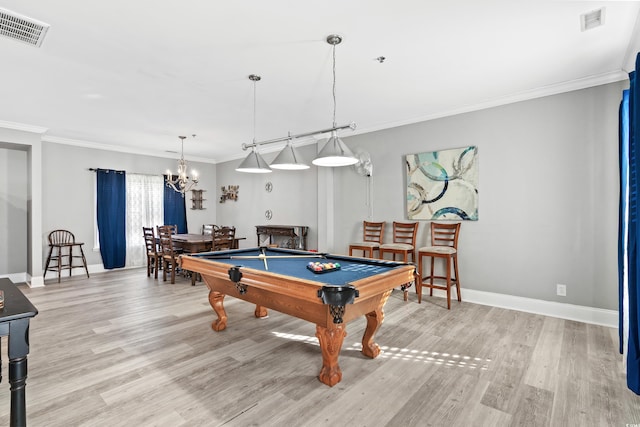 playroom featuring light wood-style flooring, crown molding, visible vents, and baseboards