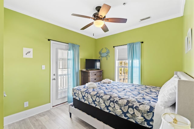 bedroom with wood finished floors, visible vents, baseboards, access to exterior, and crown molding