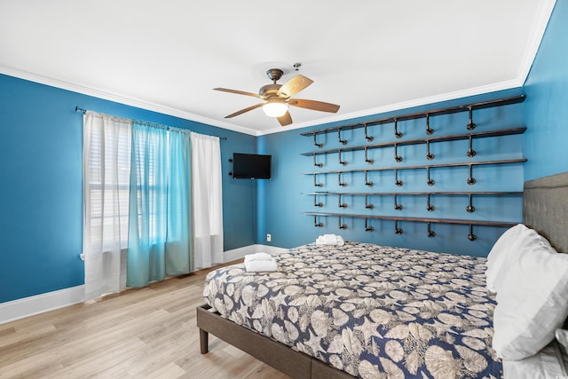 bedroom featuring baseboards, ceiling fan, wood finished floors, and crown molding