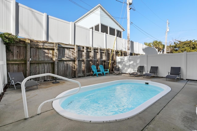 view of pool with a patio area and a fenced backyard