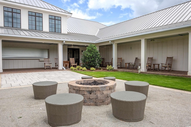 view of patio featuring ceiling fan and an outdoor fire pit