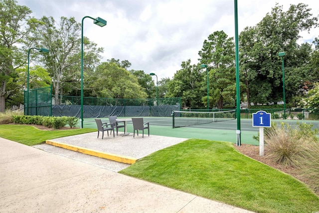 view of sport court featuring a yard