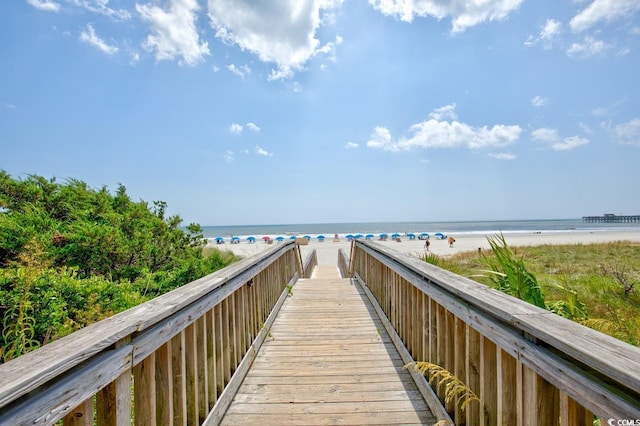 view of property's community with a view of the beach and a water view