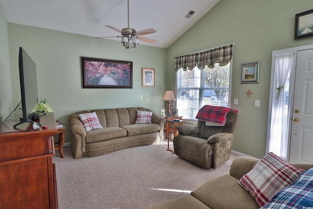 living room featuring ceiling fan, carpet floors, and vaulted ceiling