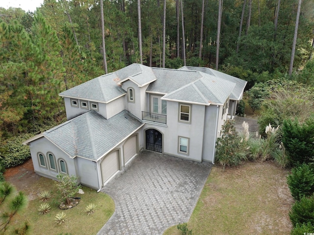 view of front of house featuring a garage and a balcony