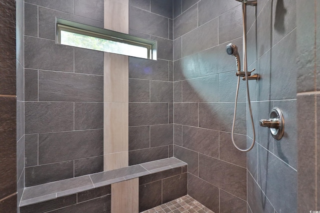 bathroom with a tile shower