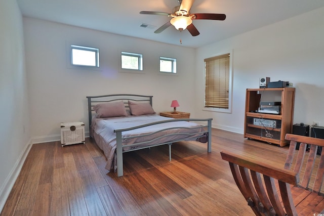 bedroom with ceiling fan and wood-type flooring