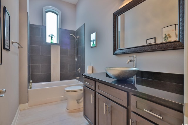 full bathroom with tiled shower / bath, vanity, and toilet