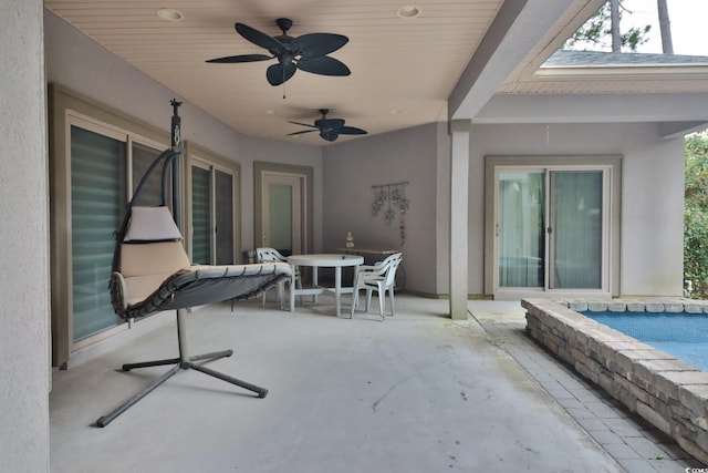 view of patio / terrace with ceiling fan and a swimming pool