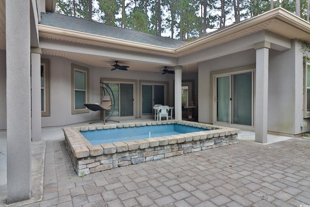 view of swimming pool featuring a jacuzzi, ceiling fan, and a patio area