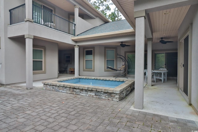 view of swimming pool with a patio, ceiling fan, and an in ground hot tub