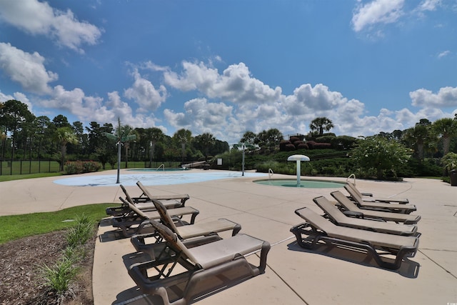 view of swimming pool with a patio