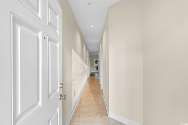 hall featuring light tile patterned floors