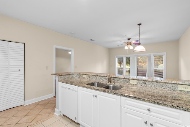 kitchen featuring white cabinets, decorative light fixtures, sink, and white dishwasher