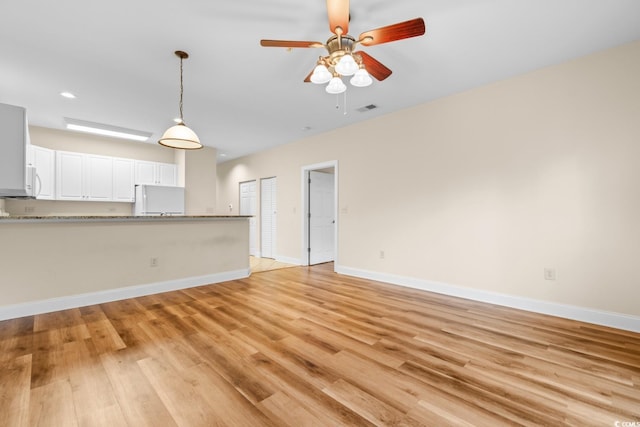 unfurnished living room featuring light hardwood / wood-style floors and ceiling fan