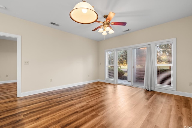 empty room featuring wood-type flooring and ceiling fan