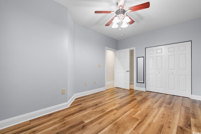 unfurnished bedroom featuring a closet, light hardwood / wood-style floors, and ceiling fan