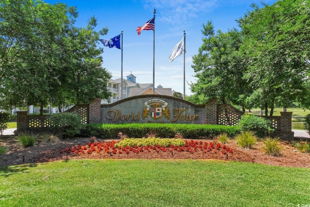 community sign featuring a lawn