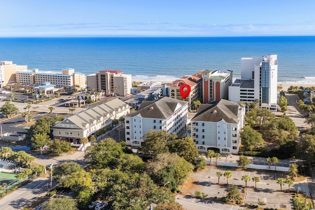 drone / aerial view featuring a beach view and a water view