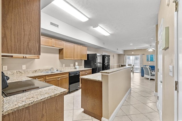 kitchen with ceiling fan, a textured ceiling, light tile patterned floors, and black appliances