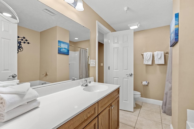 full bathroom featuring tile patterned floors, vanity, a textured ceiling, toilet, and shower / bath combo with shower curtain