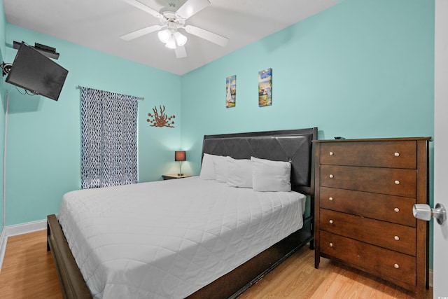 bedroom with light hardwood / wood-style floors and ceiling fan