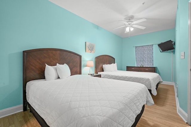 bedroom featuring light hardwood / wood-style flooring and ceiling fan