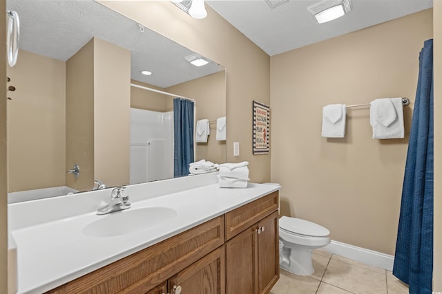 bathroom with toilet, vanity, a textured ceiling, and tile patterned floors