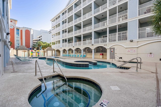 view of pool featuring a hot tub