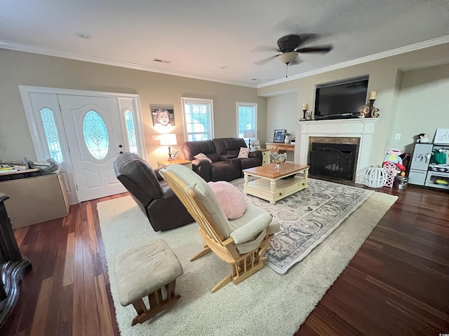 living room featuring dark hardwood / wood-style floors, ceiling fan, and ornamental molding